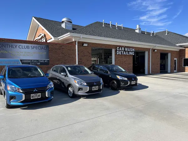 A MEGA Auto Spa car wash and detailing building with freshly washed cars parked out front